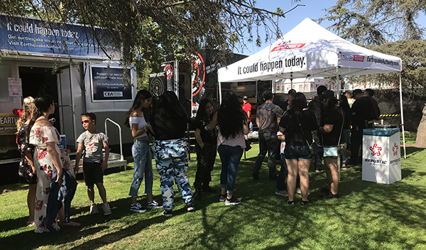 Image: Concertgoers lining up to experience a high magnitude earthquake simulation