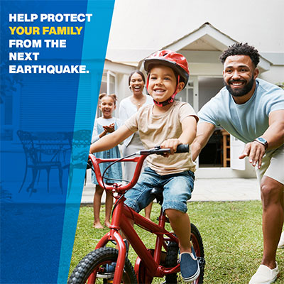 Image: Family in front of house with young child on bike